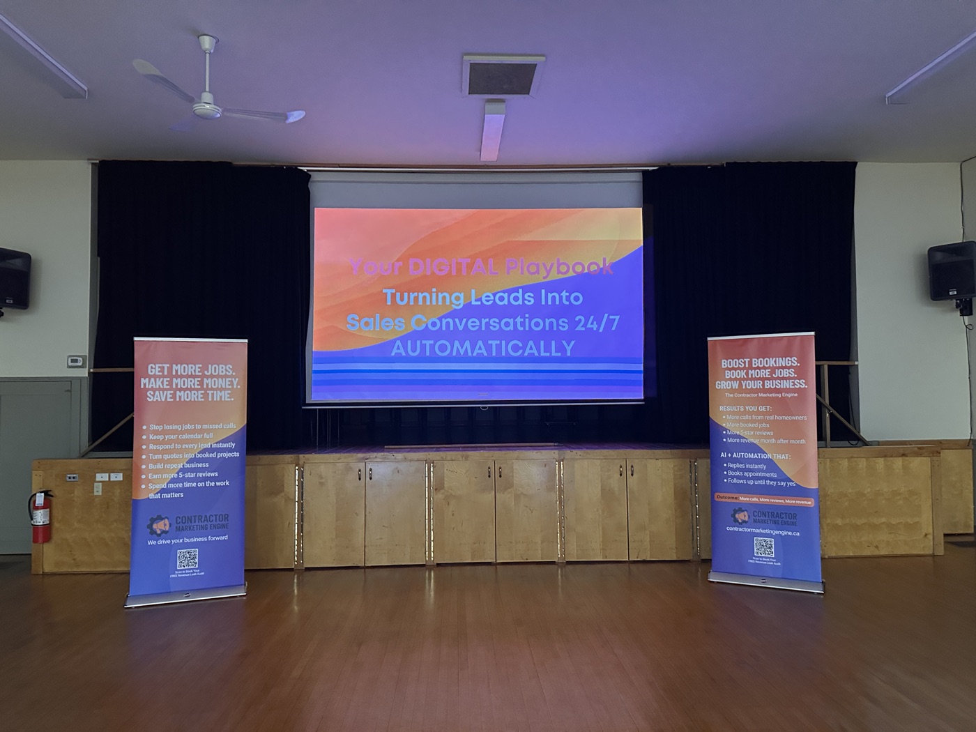 PM Consulting workshop setup at an Ontario community hall — Contractor Marketing Engine banners and projection screen